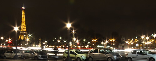 Cars in motion. Cars parked. Lamppost starburst. The Eiffel Tower