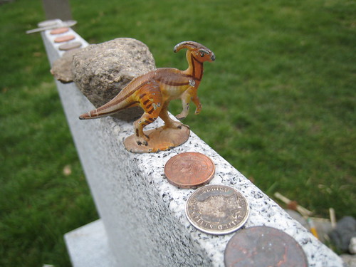 Toy dinosaur atop Lovecraft grave