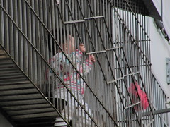 Child playing on the caged balcony