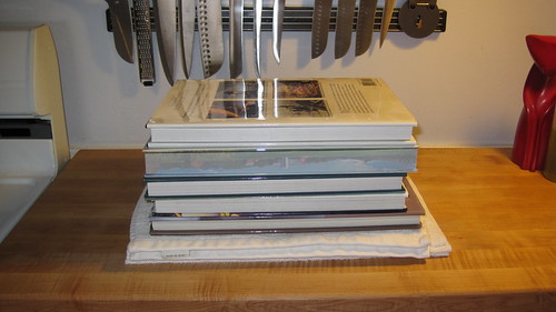 Step Five: Place, one by one, large, heavy coffee table books, until you've added about 10 pounds of books. Let the tofu press for at least one hour before removing the weights.