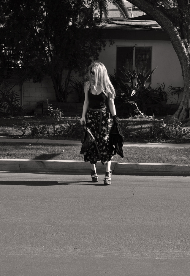 bw walking across the street + calf-length floral skirt and a tank top