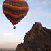 Hot air balloon passes close to hilltop - Cappadocia, Turkey
