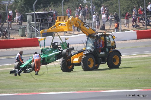 Marcus Ericsson's Caterham is recovered after spinning off during Free Practice 1 at the 2014 British Grand Prix