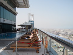 Hotel rooftop with pool and view.
