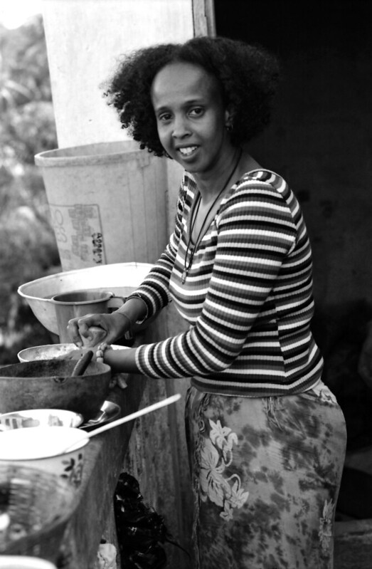 Togo West Africa Goat Head Soup Preparation with Fouzia Village close to Palimé formerly known as Kpalimé is a city in Plateaux Region Togo near the Ghanaian border B&W 23 April 1999 074 Fouzia Cooking<br/>© <a href="https://flickr.com/people/41087279@N00" target="_blank" rel="nofollow">41087279@N00</a> (<a href="https://flickr.com/photo.gne?id=13923689331" target="_blank" rel="nofollow">Flickr</a>)