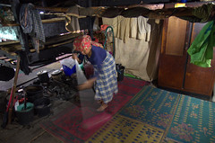 Woman cleaning in Karo Batak house