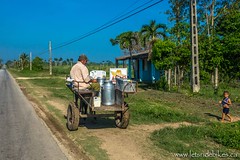 The milkman making a delivery, in rural Cuba.
