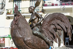 A naked woman on a giant Rooster in Havana.