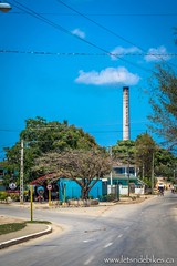 Riding back into Niquero, Cuba, the skyline dominated by the sugar factory.