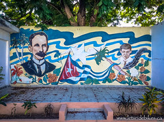 A mural on the wall outside of a school. I believe the man on the left is Jose Marti.