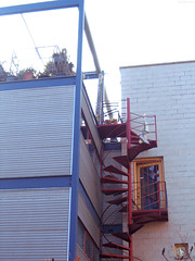 Red spiral staircase up to vertical house • <a style="font-size:0.8em;" href="http://www.flickr.com/photos/34843984@N07/14925996844/" target="_blank">View on Flickr</a>
