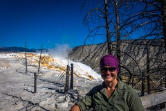 Amanda poses in front of Canary Spring; Mammoth Hot Springs, Yellowstone NP