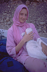 Young Australian woman with a baby goat, Mauritania