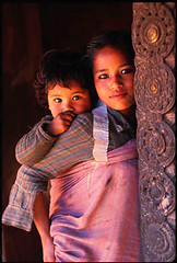 Young girl carrying her sibling on her back - Bhaktapur, Nepal
