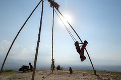 Children on bamboo swings over Kathmandu Valley