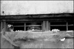 A child peers out from inside of the Pasay City Jail