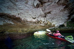 Kayakers Under Limestone in Palau © Mark Downey