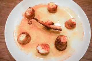Spanish octopus atop of thin potato coins