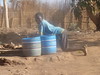 Lupia collecting water from the well